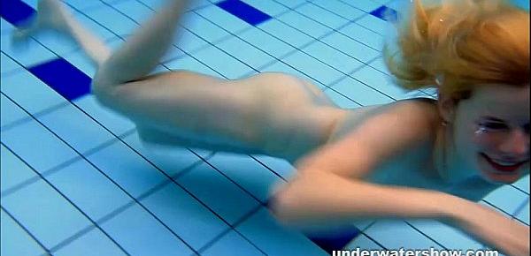  Cute Lucie is stripping underwater